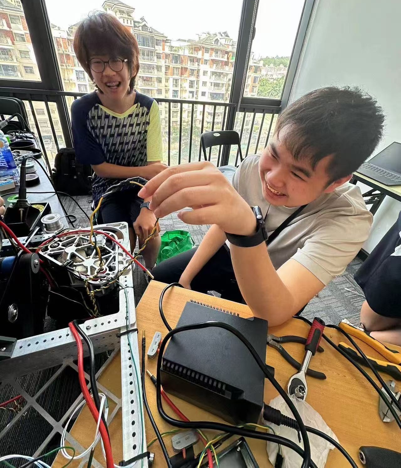 Students wiring and testing robotics hardware for FRC.