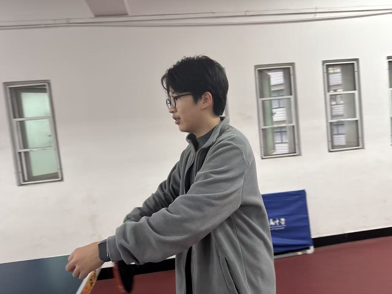 Jeffery playing ping pong on campus.